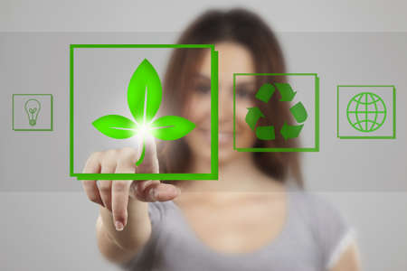 Young woman pointing at recicle iconsの写真素材