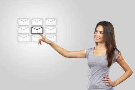 Businesswoman pressing message iconの写真素材