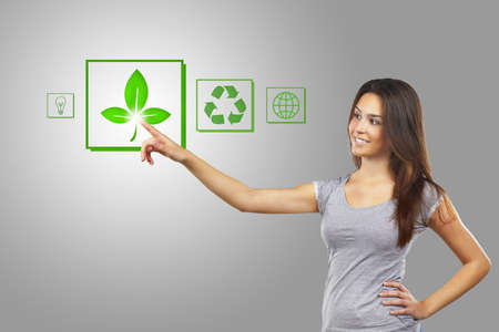 Young woman pointing at eco iconsの写真素材