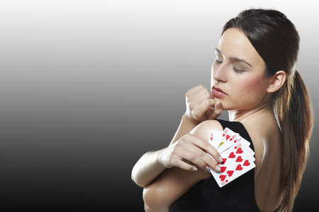 Sexy young woman with poker cardsの写真素材