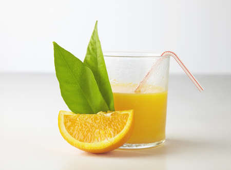 Orange juice and slices of orangeの写真素材