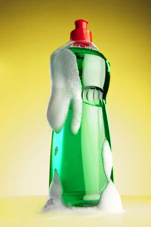 still life of a bottle of detergent on a yellow backgroundの写真素材
