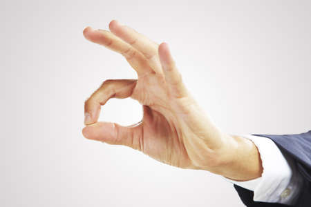 Businessman s hand showing OK signの写真素材