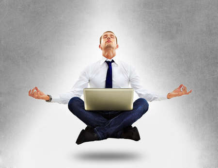 Businessman sitting in yoga positionの写真素材