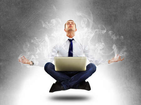 Yoga businessman in total concentrationの写真素材