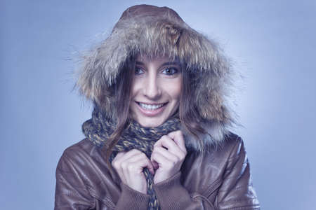 beautiful girl wearing fur lined coat hood and smiling