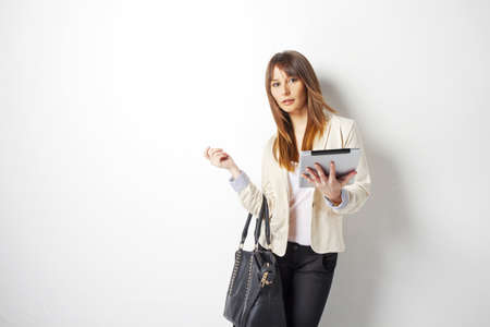 Business woman using her digital tablet isolated on whiteの写真素材
