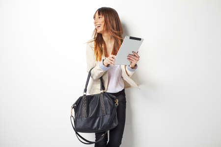 Business woman using her digital tablet isolated on whiteの写真素材