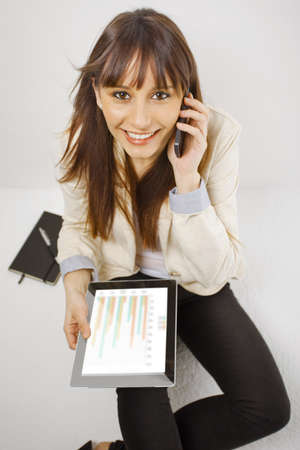 Young business woman with digital tablet isolated on whiteの写真素材