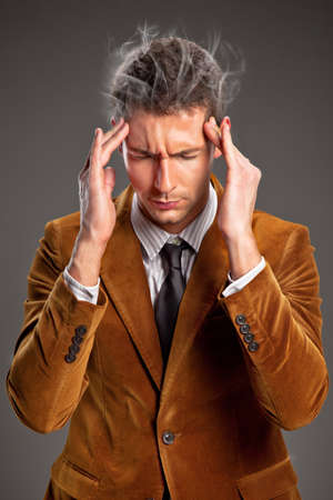 Portrait of attractive young businessman thinkingの写真素材