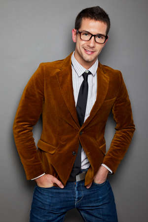 Portrait of attractive businessman on grey backgroundの写真素材