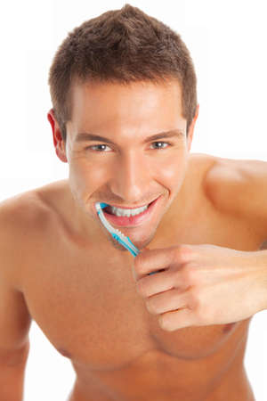 Man brushing teeth isolated on whiteの写真素材