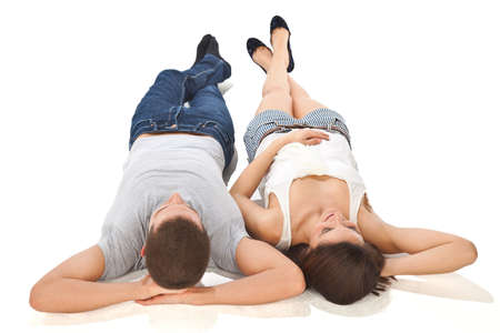 A couple lying isolated on whiteの写真素材