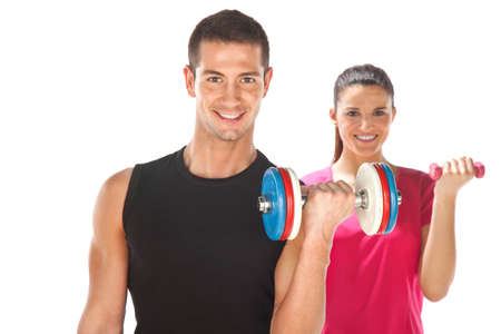 Young couple exercising with weights togetherの写真素材