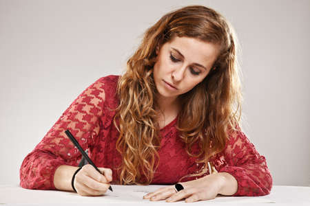 Portrait of a young woman over grey backgroundの写真素材