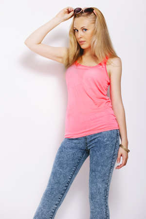 Young woman with pink shirt in studio の写真素材