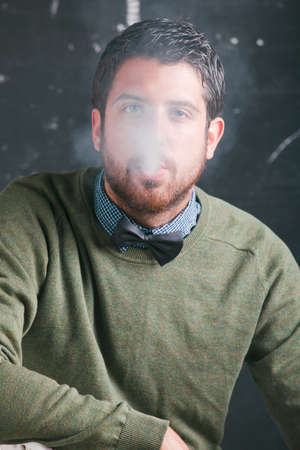 Caucasian man sitting and smoking の写真素材