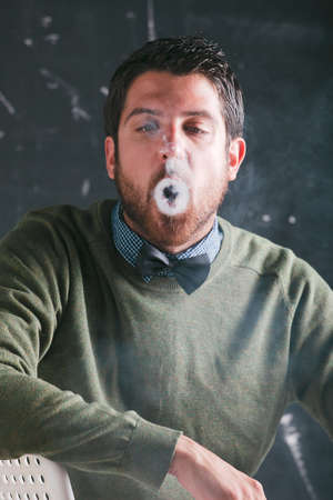 Caucasian man sitting and smoking の写真素材