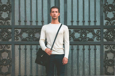 Young businessman with a briefcase looking at camera 