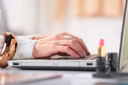 Young creative woman typing on a laptop in her office の写真素材
