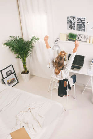 Mature woman with computer at desk 