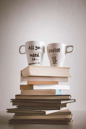 Hipster cup of coffee over a books の写真素材