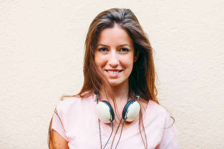 Beautiful woman with headphones looking at camera の写真素材
