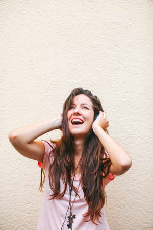 Beautiful woman listening music with headphones  の写真素材