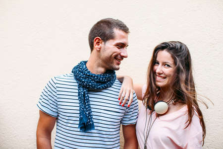 Smiling couple isolated on wall の写真素材