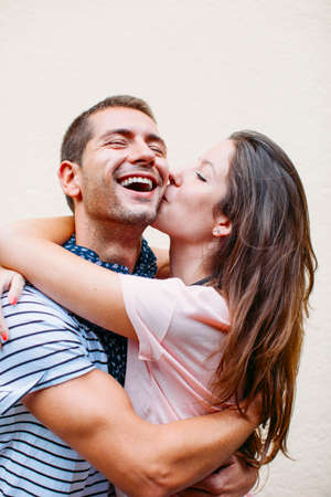 Smiling couple isolated on wall 