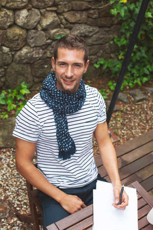 Attractive man in home garden, smilingの写真素材