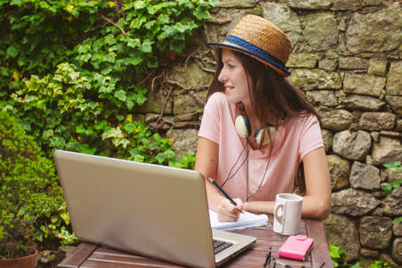 Beautiful working girl smiling in home garden の写真素材