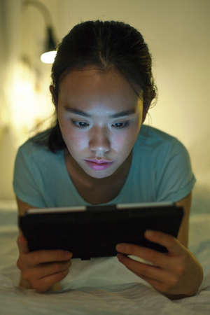Woman looking digital tablet at home.の写真素材