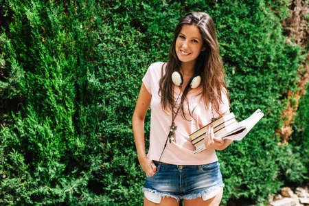 Young student woman smiling on home garden.の写真素材