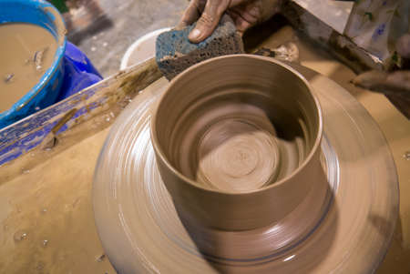asian clay potter on a potter wheel