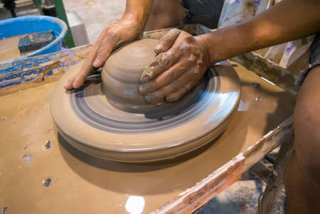 asian clay potter on a potter wheelの写真素材