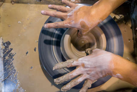 asian clay potter on a potter wheelの写真素材