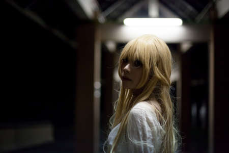 portrait of asian girl in white dress ready for halloween night,  low key pictureの写真素材