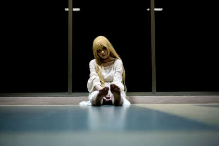 portrait of asian girl in white dress ready for halloween night,  low key pictureの写真素材