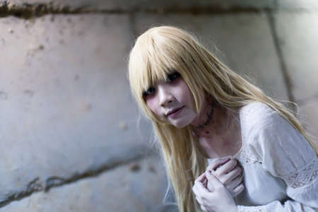 portrait of asian girl in white dress ready for halloween night,  low key picture