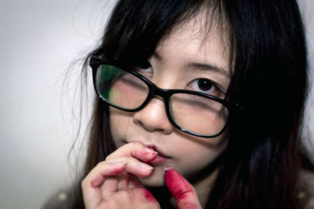 Asian halloween makeup artist stain her hands with fake bloodの写真素材