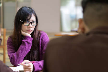 Asian girl in casual wear studying