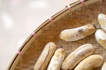 Big fly on sun dried bananaの写真素材