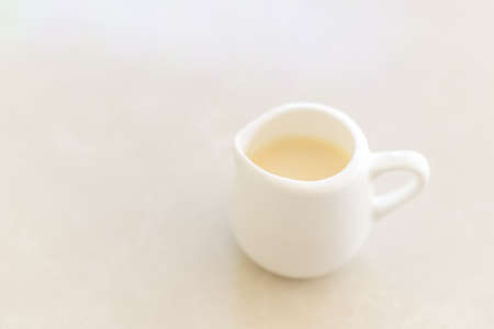 Small jar of milk serve with cofee