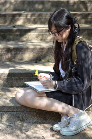 Asian girl in uniform studying in university