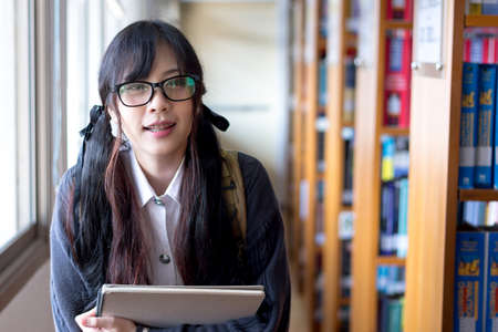 Asian girl in uniform studying in university