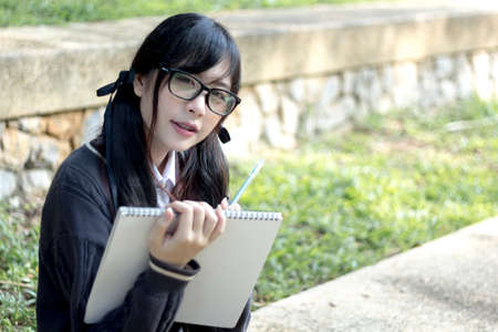 Asian girl in uniform studying in university