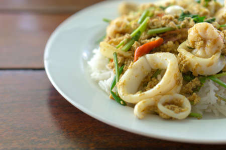 Thai stir fried curry seafood with riceの写真素材