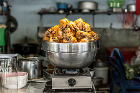 Stewed pork legs on steaming potの写真素材