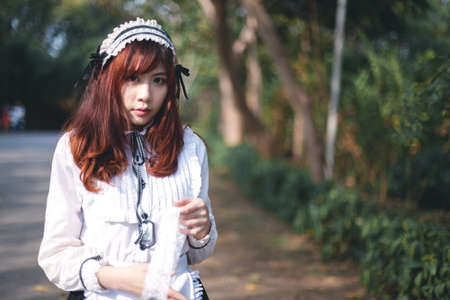 Charming Asian girl in japanese maid costume in film color style